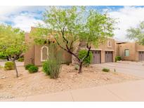 Neutral stucco exterior with stone accents, arched windows, mature trees, and manicured desert landscaping at 13300 E Via Linda -- # 1065, Scottsdale, AZ 85259