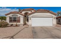 Charming single-story home with a well-maintained front yard and attached two-car garage at 17943 N Woodrose Ave, Surprise, AZ 85374