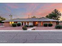 Charming single-story brick home with tidy landscaping, set against a colorful twilight sky at 2148 E Cairo Dr, Tempe, AZ 85282