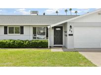 Charming single-story home features a well-manicured lawn, white brick exterior, and black front door at 23 W Fairmont Dr, Tempe, AZ 85282