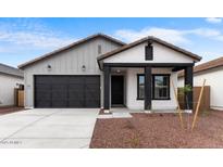 Charming single-story home with a black garage door and desert landscaping at 23403 W Albeniz Pl, Buckeye, AZ 85326