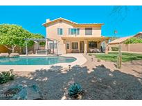 Inviting backyard featuring a sparkling pool, pergola, desert landscaping, and a covered patio perfect for outdoor entertaining at 5513 E Grovers Ave, Scottsdale, AZ 85254
