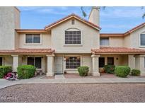Inviting two-story townhouse featuring a red tile roof and a well-maintained stucco facade at 5808 E Brown Rd # 140, Mesa, AZ 85205