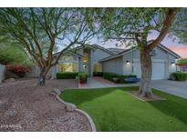 Charming single-story home with mature landscaping and a well-manicured artificial lawn at 9015 E Altadena Ave, Scottsdale, AZ 85260