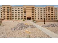 Multi-level condo building featuring balconies, desert landscaping, and covered entry at 7960 E Camelback Rd # 110, Scottsdale, AZ 85251