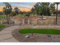 A stunning desert home features a circular driveway with drought-resistant landscaping and an attractive front entrance at 11416 N Blackheath Rd, Scottsdale, AZ 85254