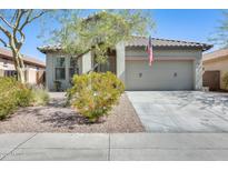 Charming single-story home featuring a neutral color palette, well-maintained landscaping, and a two-car garage at 11988 W Nadine Way, Peoria, AZ 85383