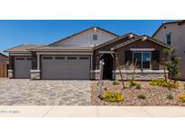 Inviting single-Gathering home featuring a neutral color palette, paver driveway and walkway, and a two-car garage at 12366 W Marguerite Ave, Avondale, AZ 85323