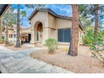 Charming single-story home featuring a stucco exterior, tiled roof, and an inviting arched entryway at 14300 W Bell Rd # 245, Surprise, AZ 85374