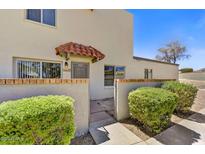Inviting front entrance featuring a charming tiled awning, beautiful landscaping, and address numbers at 14414 N Boxwood Ln, Fountain Hills, AZ 85268