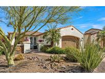 Charming single-story home with desert landscaping, a private gate, and an attached two-car garage at 1556 E Vesper Trl, Queen Creek, AZ 85140