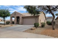 Charming single-story home with a low-maintenance landscaped front yard and an attached two-car garage at 17151 W Mohave St, Goodyear, AZ 85338