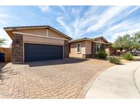 View of the exterior of a single-story home with a brick driveway and landscaping at 22434 S 226Th Pl, Queen Creek, AZ 85142