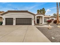 Charming single-story home featuring a three-car garage and a well-manicured desert landscape at 2732 E Hillery Dr, Phoenix, AZ 85032