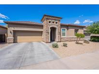 Charming single-story home featuring a stone facade, desert landscaping, and a two-car garage at 3028 W T Ryan Ln, Phoenix, AZ 85041
