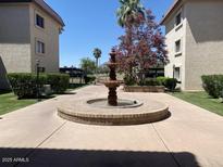 Charming water fountain surrounded by a meticulously kept landscape at 3033 E Devonshire Ave # 3003, Phoenix, AZ 85016