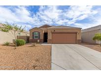 Charming single-story home with a neutral color palette, desert landscaping, and a two-car garage at 30993 W Indianola Ave, Buckeye, AZ 85396