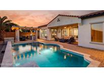 Backyard pool with an outdoor kitchen and covered seating area at 3673 E Horseshoe Dr, Chandler, AZ 85249