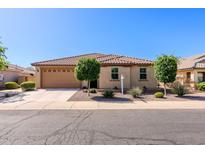 Charming single-story home featuring a tile roof, well-manicured front yard, and a two-car garage at 40707 W Pryor Ln, Maricopa, AZ 85138