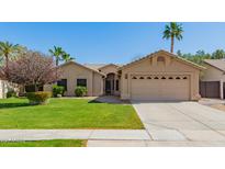 Charming single-story home with well-maintained landscaping, mature trees, and a two-car garage at 4901 S Vista Pl, Chandler, AZ 85248