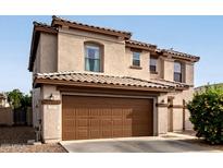 Two-story home featuring a tile roof and a spacious two-car garage at 559 W Viola St, Casa Grande, AZ 85122