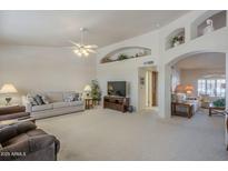 The spacious living room features vaulted ceilings, neutral colors, carpeted floors, and an open floorplan at 7925 E Monte Ave, Mesa, AZ 85209