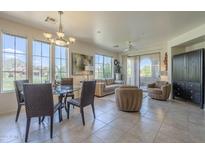 Bright open-concept living room featuring large windows and comfortable seating with backyard view at 10655 N 9Th St # 115, Phoenix, AZ 85020
