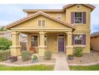 Inviting home exterior with a covered porch, tidy landscaping, and a cozy chair to relax on the porch at 2873 S Arroyo Ln, Gilbert, AZ 85295