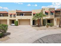 Inviting multi-level home with desert landscaping, covered balconies, and a two-car garage at 10235 N 31St St # 17, Phoenix, AZ 85028