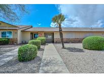Charming single-story home with well-maintained landscaping and a quaint walkway at 18610 N Mica Dr, Sun City West, AZ 85375