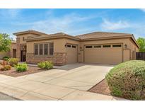 Attractive home featuring a well-maintained lawn, three-car garage, and desert landscaping at 1933 E Lafayette Ave, Gilbert, AZ 85298