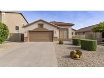 Charming single-story home featuring a neutral stucco facade, low maintenance landscaping, and an attached two-car garage at 664 W Desert Basin Dr, San Tan Valley, AZ 85143