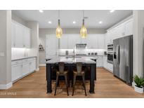 Modern kitchen featuring a large island, stainless steel appliances, and custom white cabinetry at 8340 E Mcdonald Dr # 1016, Scottsdale, AZ 85250
