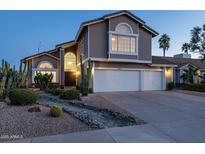Charming two-story home boasts a three-car garage, desert landscaping, and eye-catching architectural details at 9035 E Lupine Ave, Scottsdale, AZ 85260