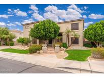 Inviting two-story home boasts mature trees, lush landscaping, and charming curb appeal at 1074 E Carla Vista Ct, Gilbert, AZ 85295