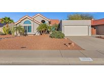 Charming single-story home with a red-tile roof, desert landscaping, and a two-car garage at 10809 N 111Th Pl, Scottsdale, AZ 85259