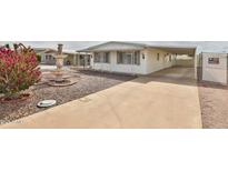 Charming home featuring a well-maintained front yard, beautiful water fountain, and covered parking at 110 S 72Nd Way, Mesa, AZ 85208