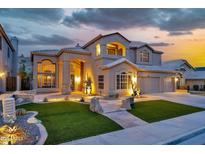Inviting two-story home with a well-manicured front yard and beautiful desert landscaping and attached garage at 15413 S 31St Pl, Phoenix, AZ 85048