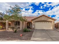 Charming single-story home with a well-maintained desert landscaped front yard and two car garage at 16424 W Cottonwood St, Surprise, AZ 85388