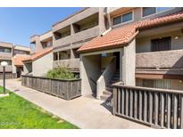 Inviting condo exterior with well-maintained landscaping, warm desert tones, and a classic tile roof at 1645 W Baseline W Rd # 2032, Mesa, AZ 85202
