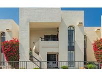 Condo exterior featuring a wrought iron fence and stairs leading to an upstairs unit with an outdoor seating area at 16739 E El Lago Blvd # 202, Fountain Hills, AZ 85268