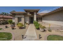 Inviting home entrance with desert landscaping and a walkway leading to the front door at 17790 N 66Th Ln, Glendale, AZ 85308