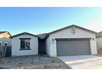 Charming single-story home with a two-car garage and a well-maintained front yard at 19045 W Rose Ln, Waddell, AZ 85355