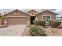 Charming single-story home with a two-car garage and desert landscaping at 22300 N Kingston Dr, Maricopa, AZ 85138