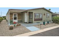 Charming single-story home with desert landscaping and a covered patio at 2400 E Baseline Ave # 94, Apache Junction, AZ 85119