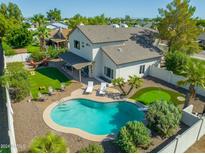 Aerial view of a backyard with a pool, lounge chairs, putting green, and covered patio area at 2818 N Yucca St, Chandler, AZ 85224