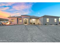 Beautiful exterior of this home featuring desert landscaping, a fire pit and charming front porch at 28204 N Royce Rd, Queen Creek, AZ 85144