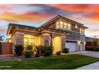 Charming two-story home with stone accents, manicured lawn, and a welcoming facade at twilight at 3749 E Sagebrush St, Gilbert, AZ 85296