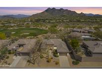 Scenic aerial view of a home, golf course, and mountain views in a beautiful community at 6214 E Evening Glow Dr, Scottsdale, AZ 85266