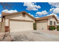 Charming beige single-Gathering home featuring an attached two-car garage and a well-maintained yard at 6335 E Brown Rd # 1098, Mesa, AZ 85205